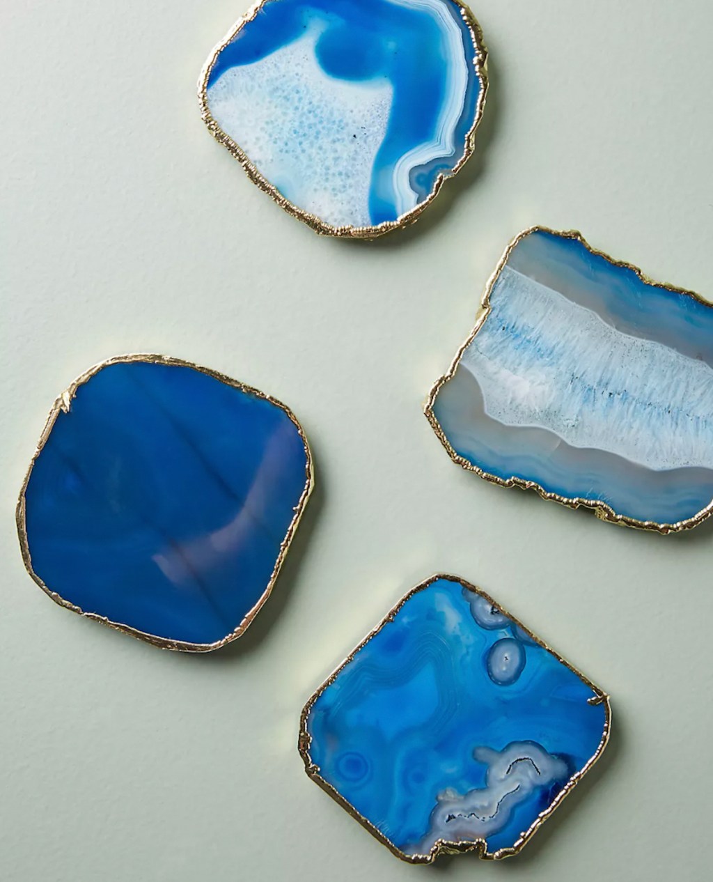 blue agate coasters on green background 