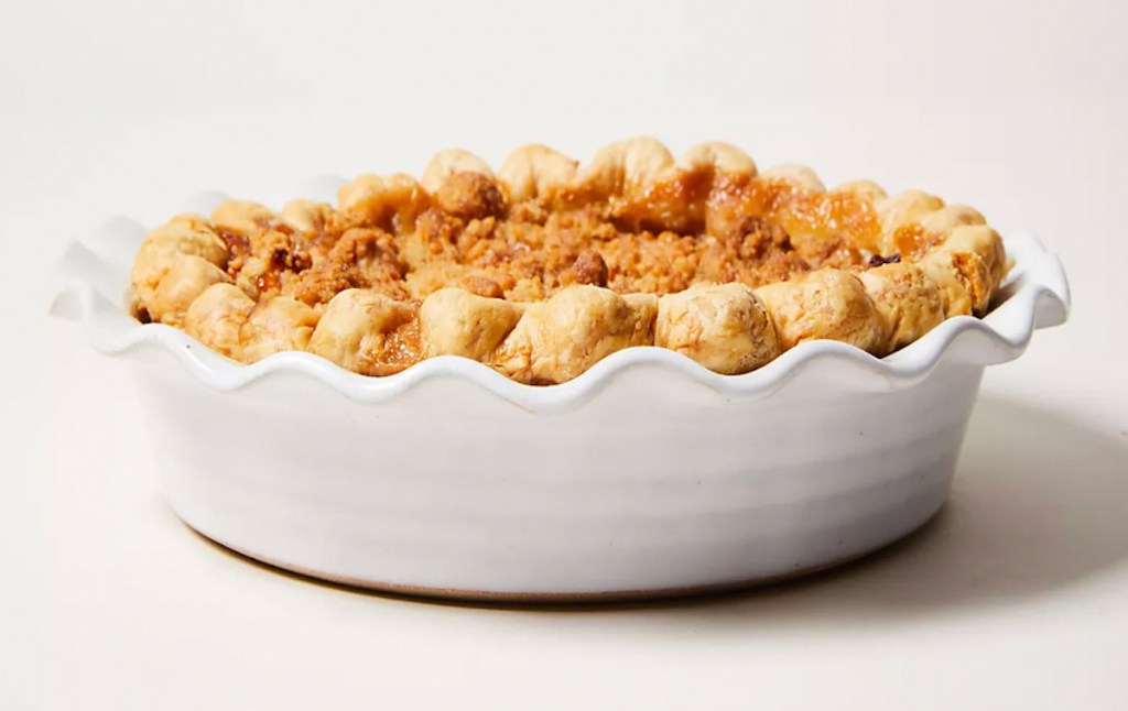 white pie dish with baked pie inside 