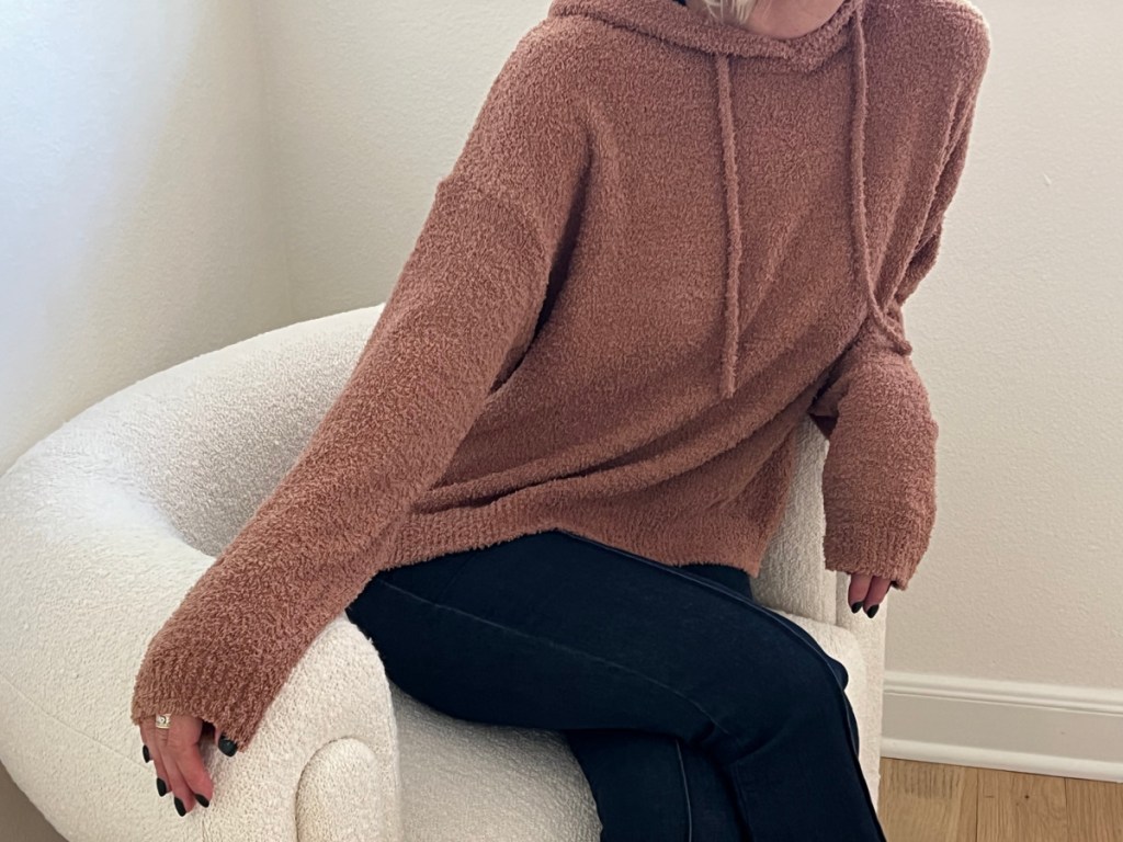 woman sitting in brown cozy pullover 