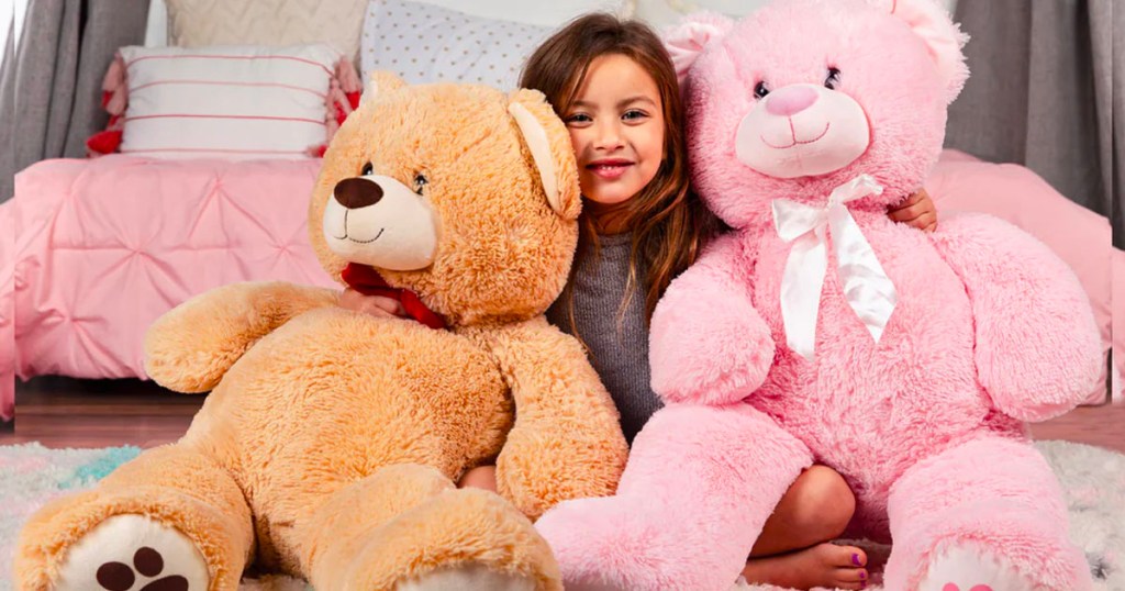 little girl in between to large stuffed bears