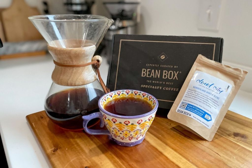 Bean Box coffee subscription box on counter beside Chemex and coffee cup