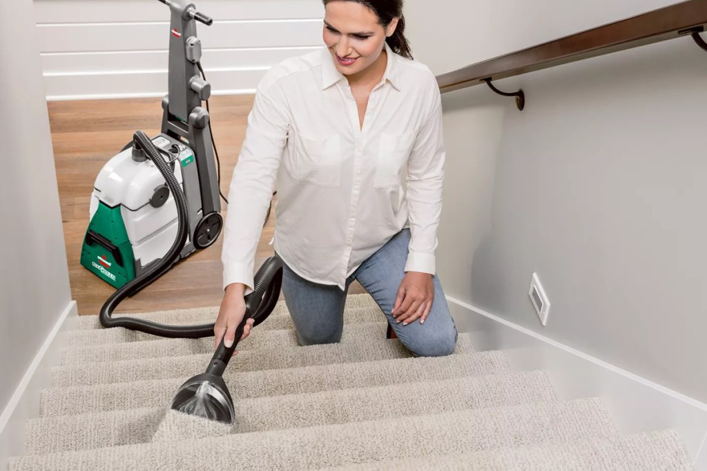 woman using BISSELL vacuum cleaner
