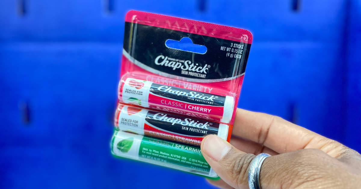 hand holding 3-pack of chapstick