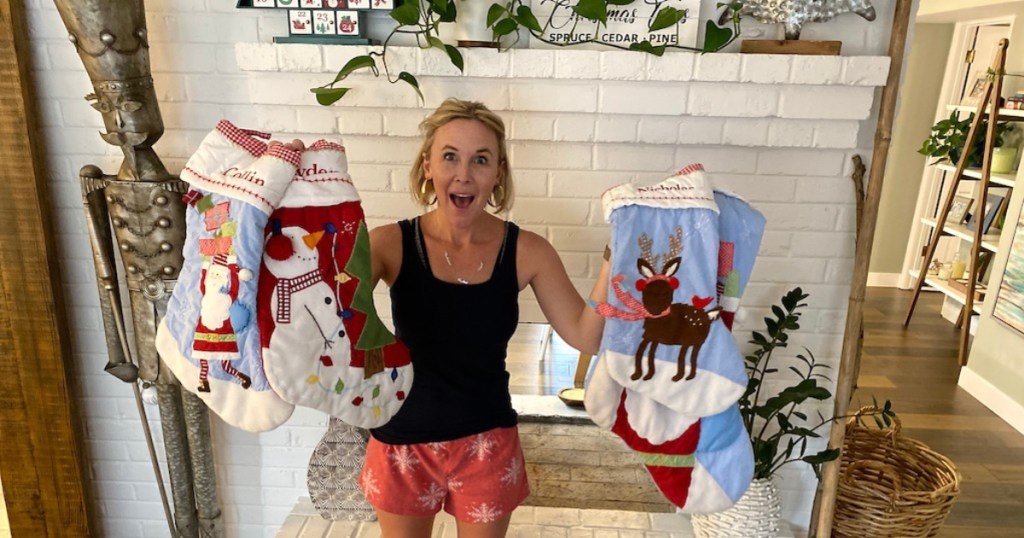 woman holding Christmas stockings