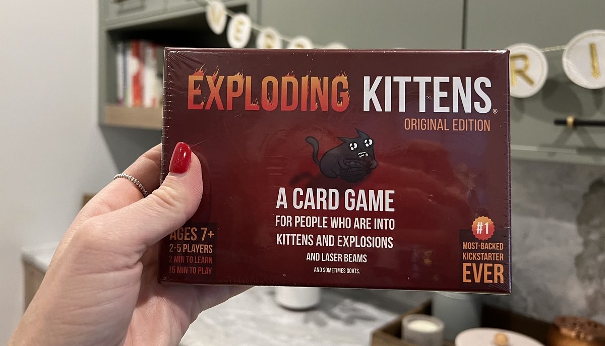 holding Exploding Kittens card game