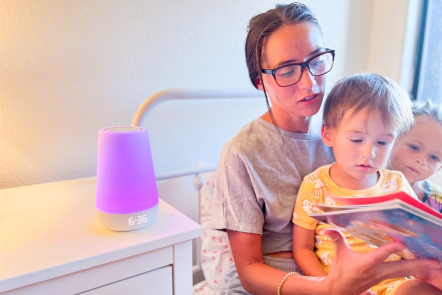 mom reading story in bed to kids