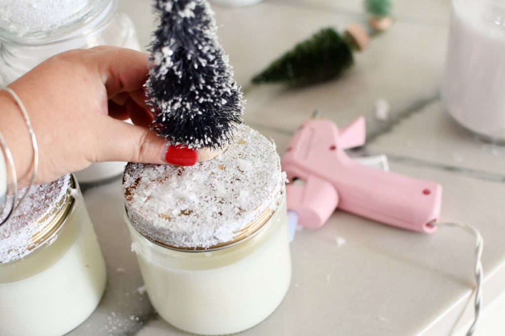 hot gluing trees to candle lid