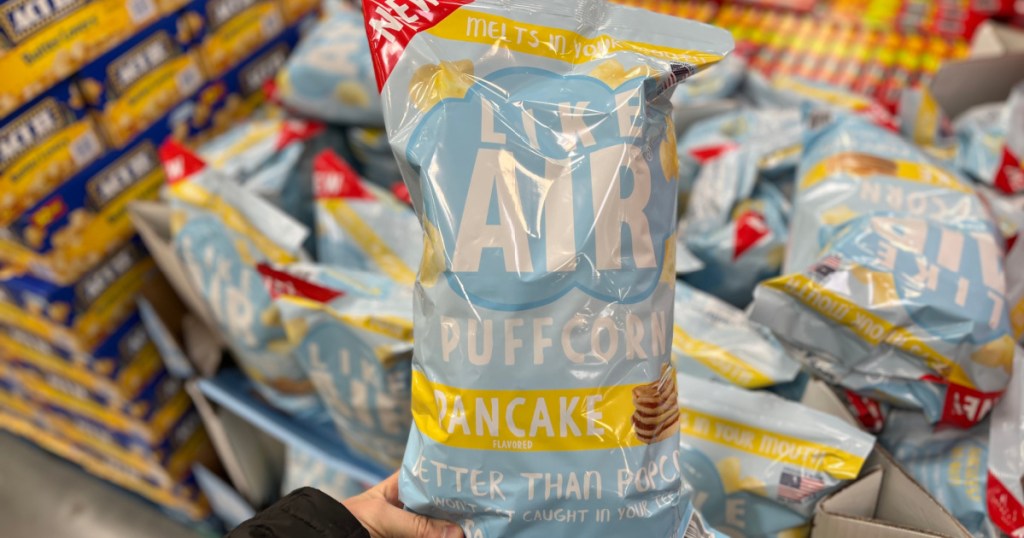 hand holding large bag of snack popcorn in store
