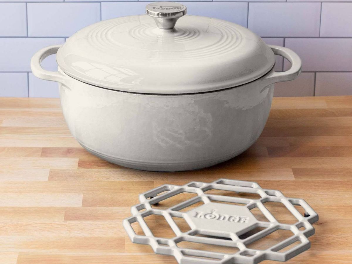 oyster colored dutch oven sitting beside matching trivet