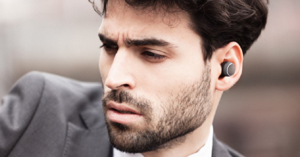 man wearing Harman Kardon Fly True Wireless Bluetooth Headphones in one ear