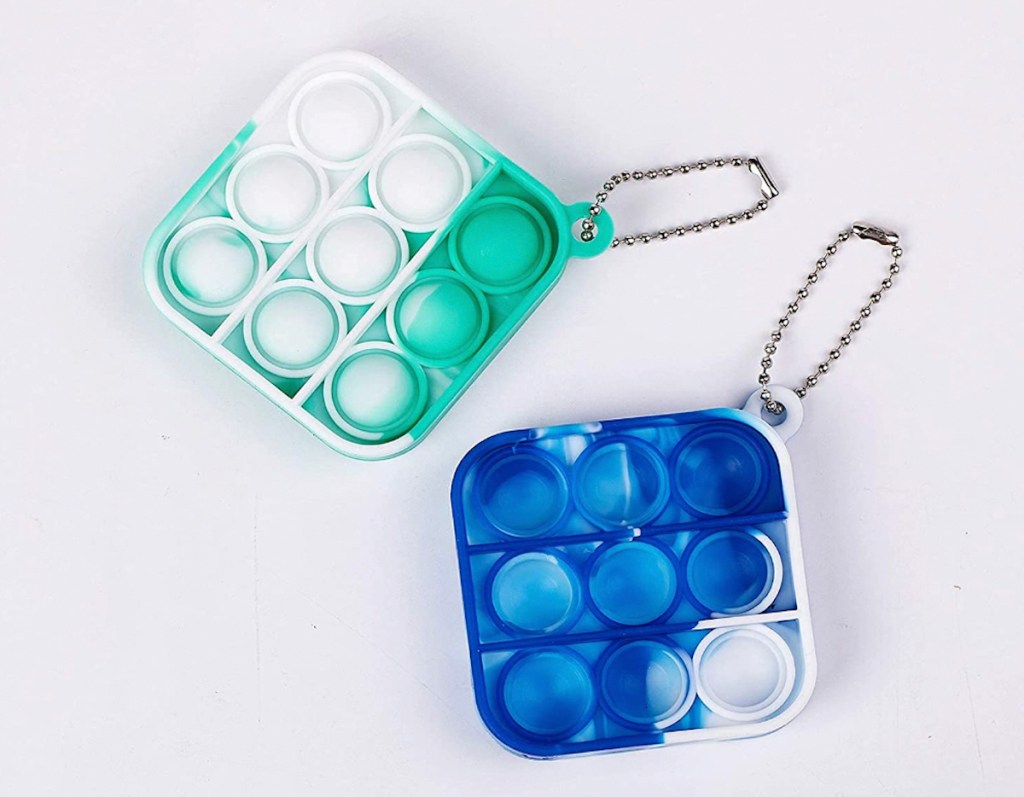 two blue and green mini pop it keychains