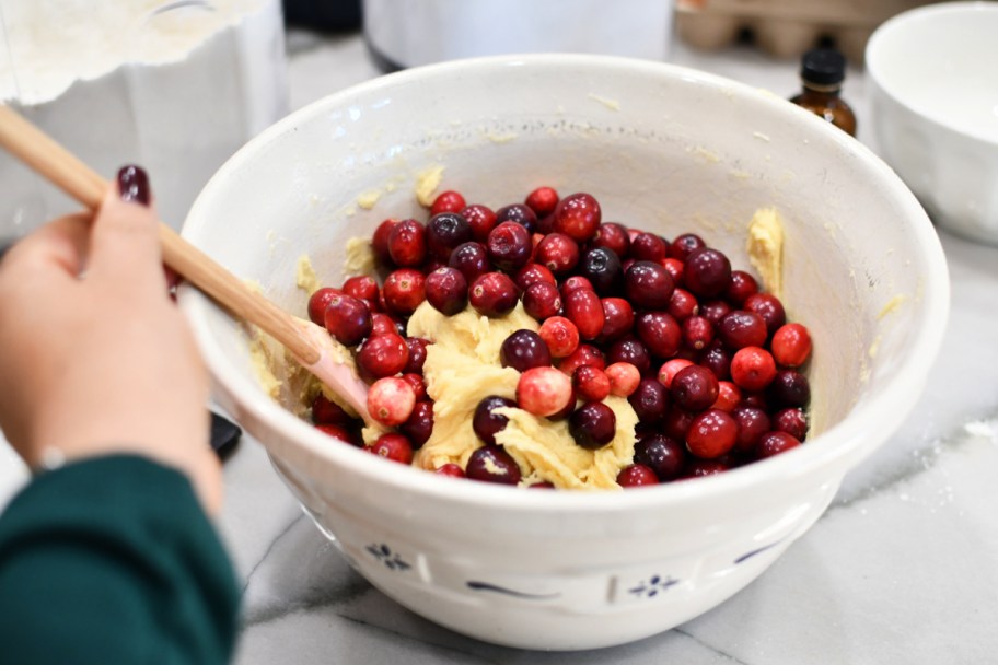 mixing cranberries in cake batter 