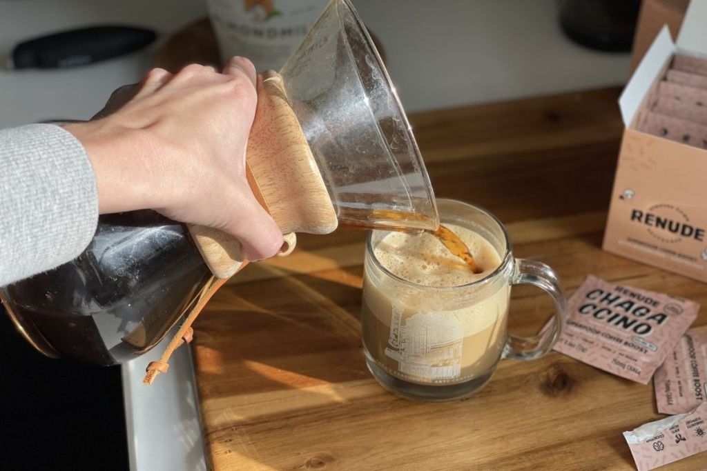 pouring coffee into frothed milk