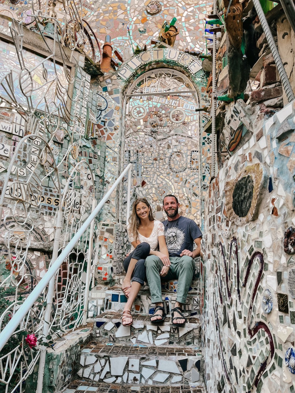 woman and man sitting in mosaic philly magic gardens