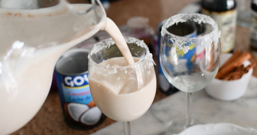 pouring a glass of coquito