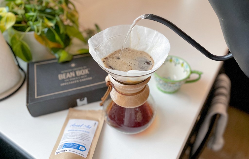 pouring water over bean box coffee grounds