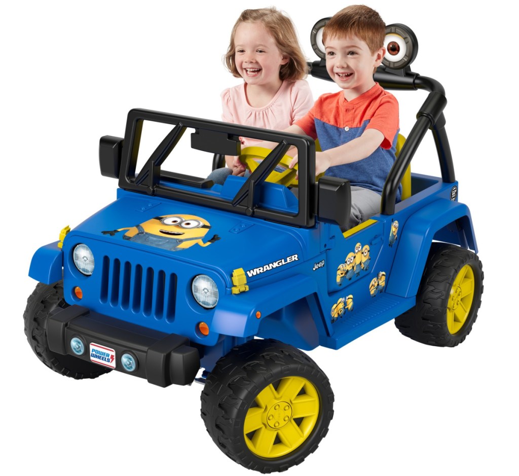 kids sitting on power wheels minions jeep