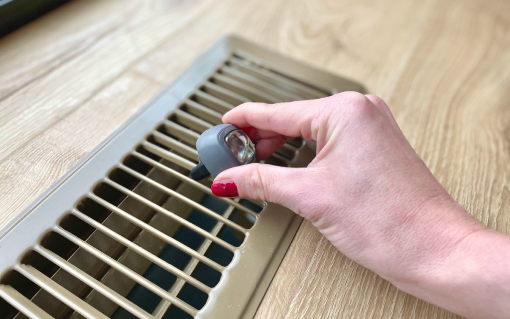 putting air freshener on vent