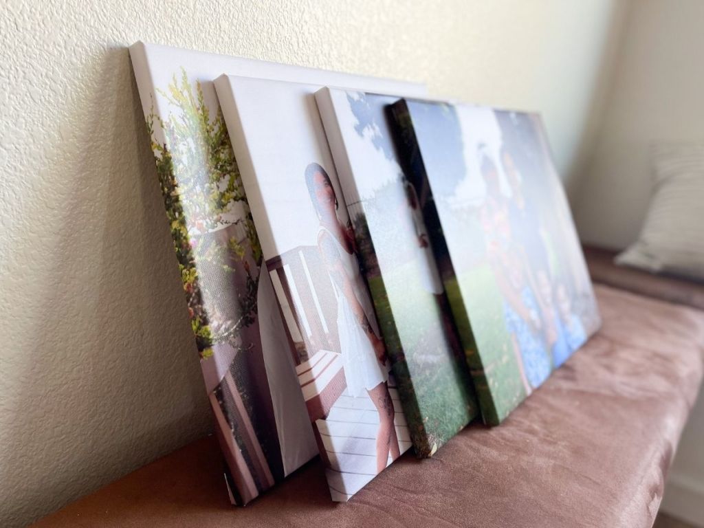 canvas prints leaning on a wall