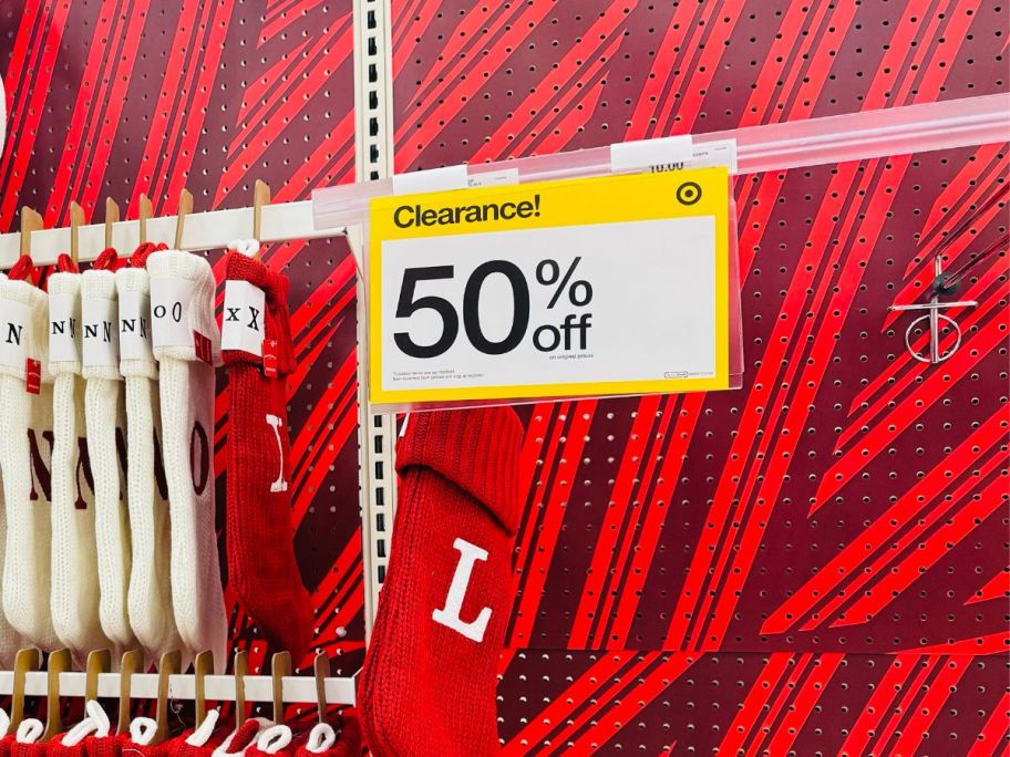 christmas stockings hanging in target with 50% off sign next to them