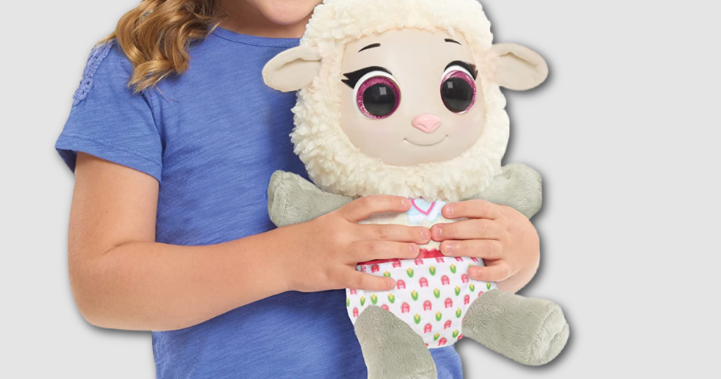 little kid holding plush sheep wearing a diaper