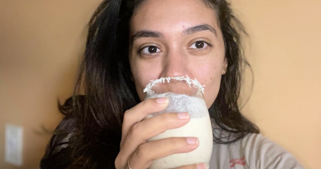 woman drinking coquito drink