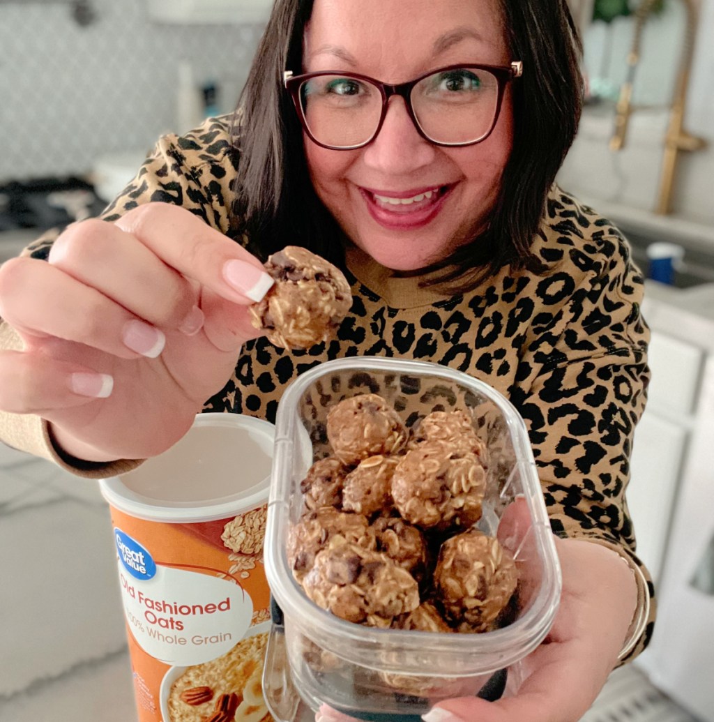 woman holding a batch of energy bites
