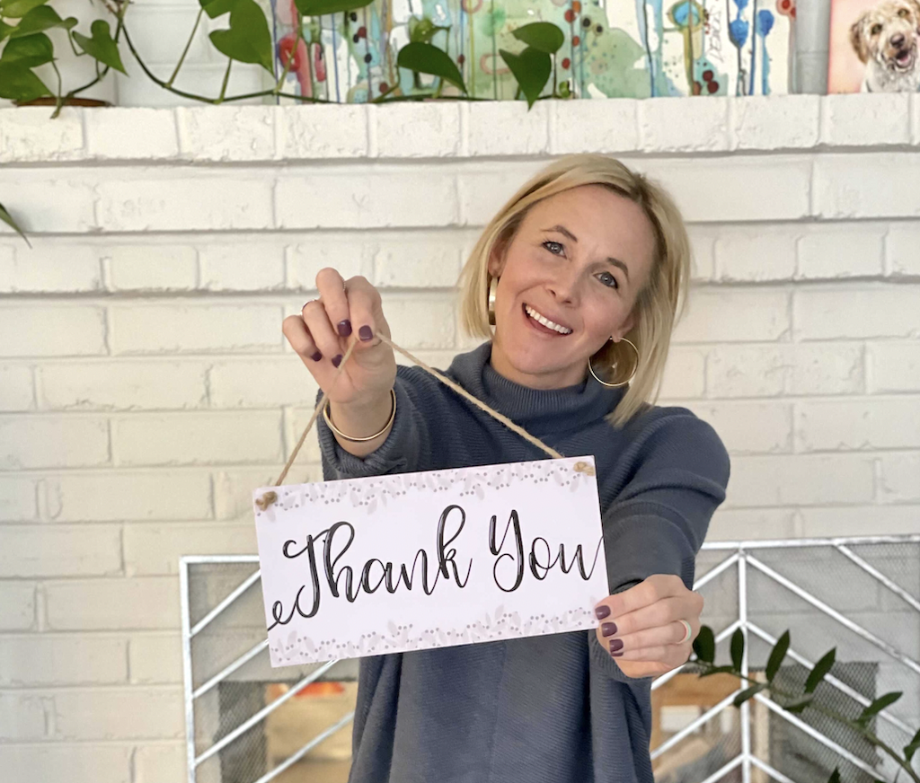 woman holding thank you sign