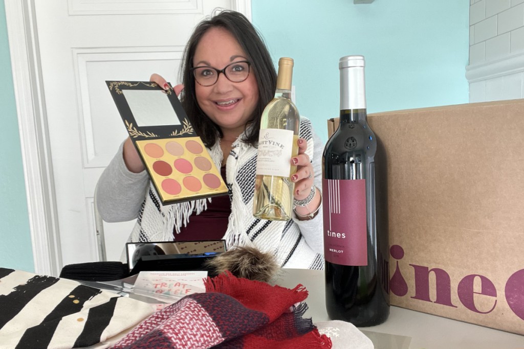woman holding ohvine wine and makeup