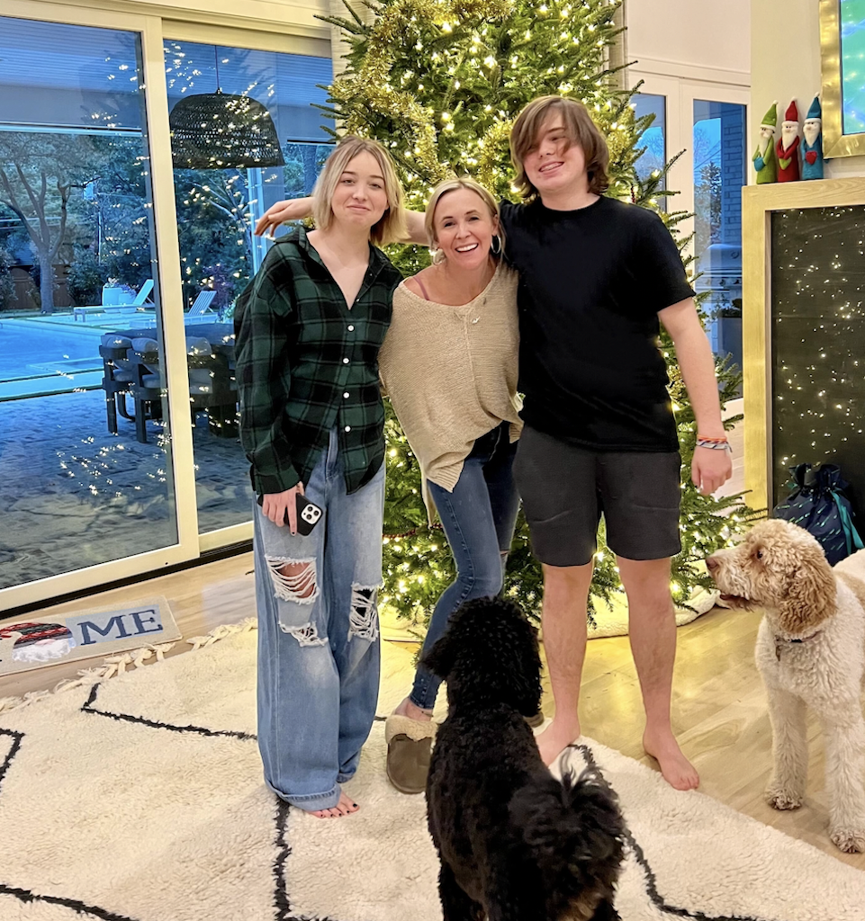 woman with teens and dogs by Christmas tree