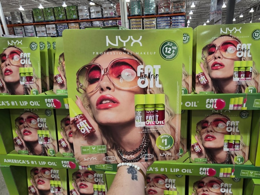 hand hodling a NYX Fat Oil Lip Drip 3-Pack in the package at Costco