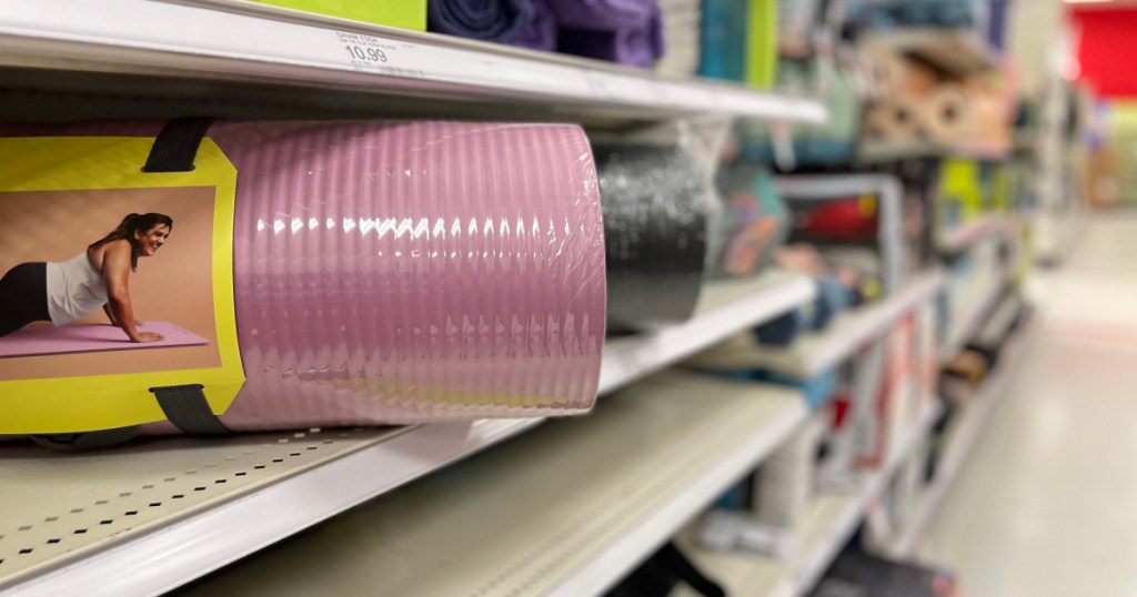 pink yoga mat rolled up on shelf