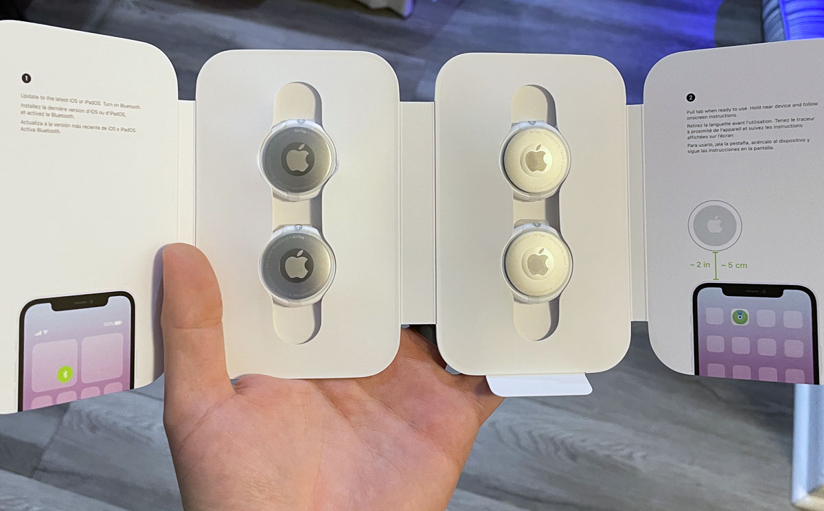 holding a 4-pack of apple airtags
