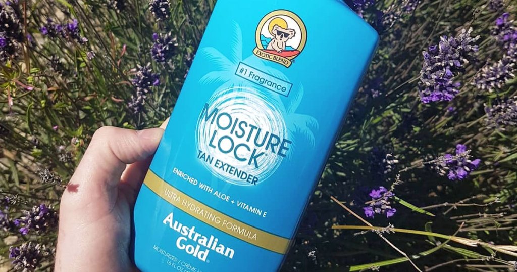 holding blue bottle of australian gold lotion