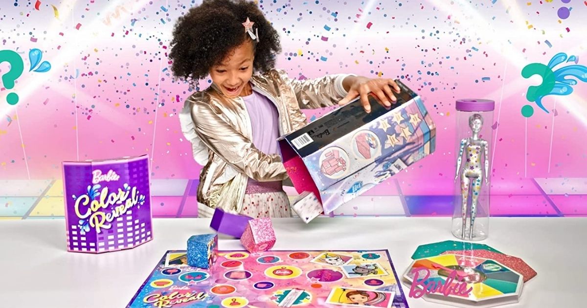 girl playing with Barbie Color Reveal Surprise Party Set