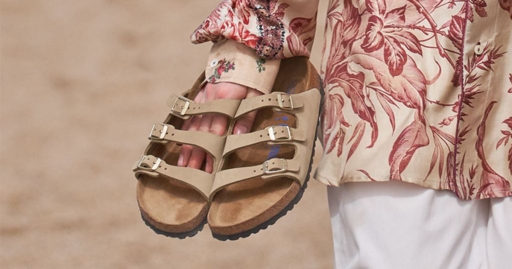person holding sandals
