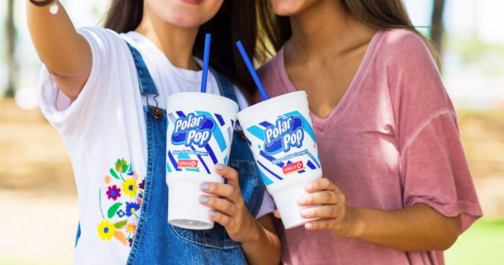 two girls holding drinks from circle k