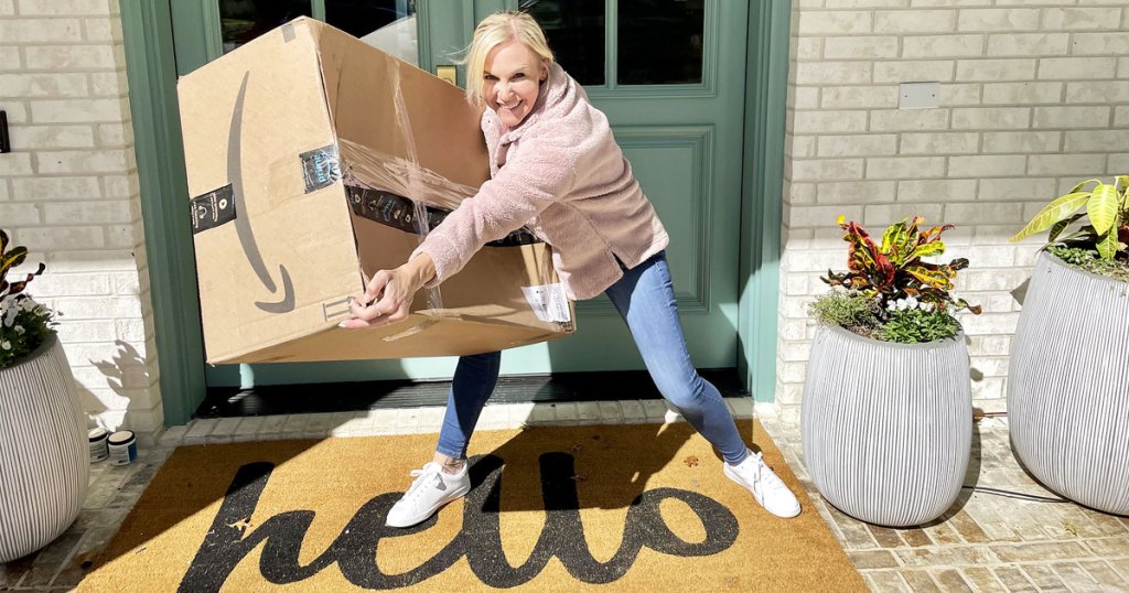 woman picking up a large amazon box