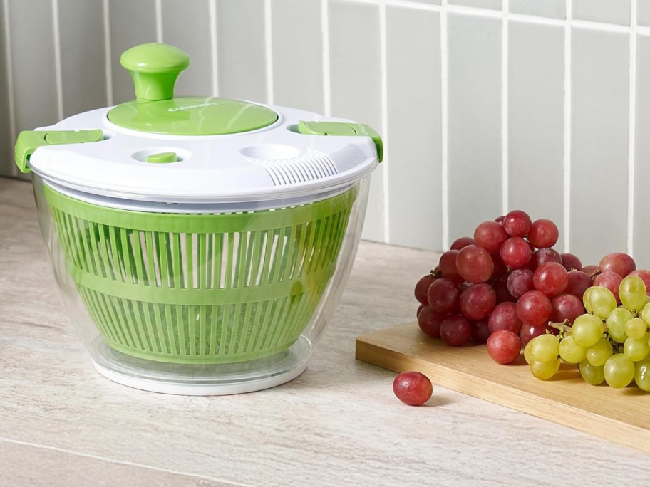 A green and white Cuisinart salad spinner on a counter.