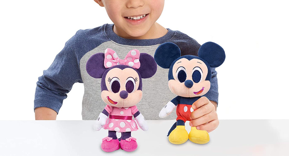 stock image of a boy playing with the Disney Junior Music Lullabies Plush Mickey Mouse and Minnie Mouse Set