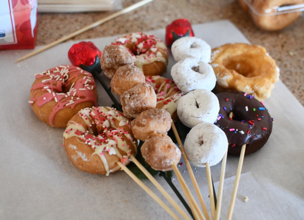 Doughnuts on wood skewers being used to make a diy donut bouquet