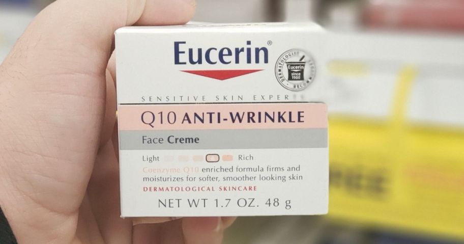 hand holding Eucerin Q10 Anti-Wrinkle cream