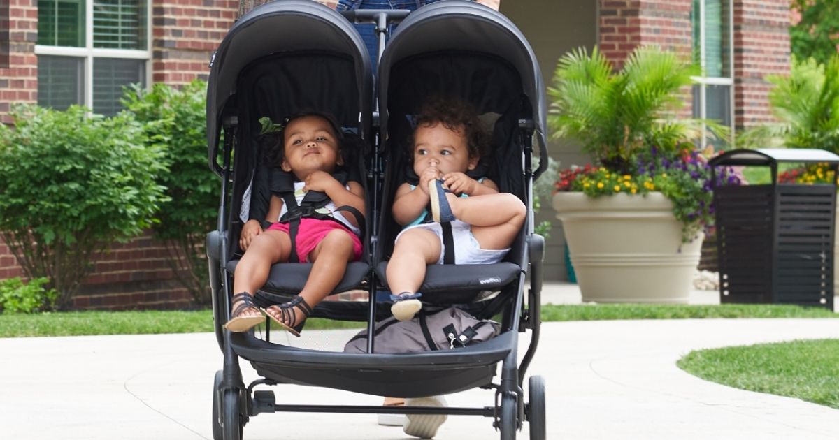 babies in evenflo aero2 double stroller in black