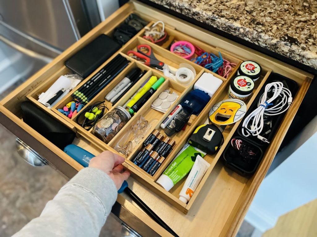 hand holding a junk drawer organizer