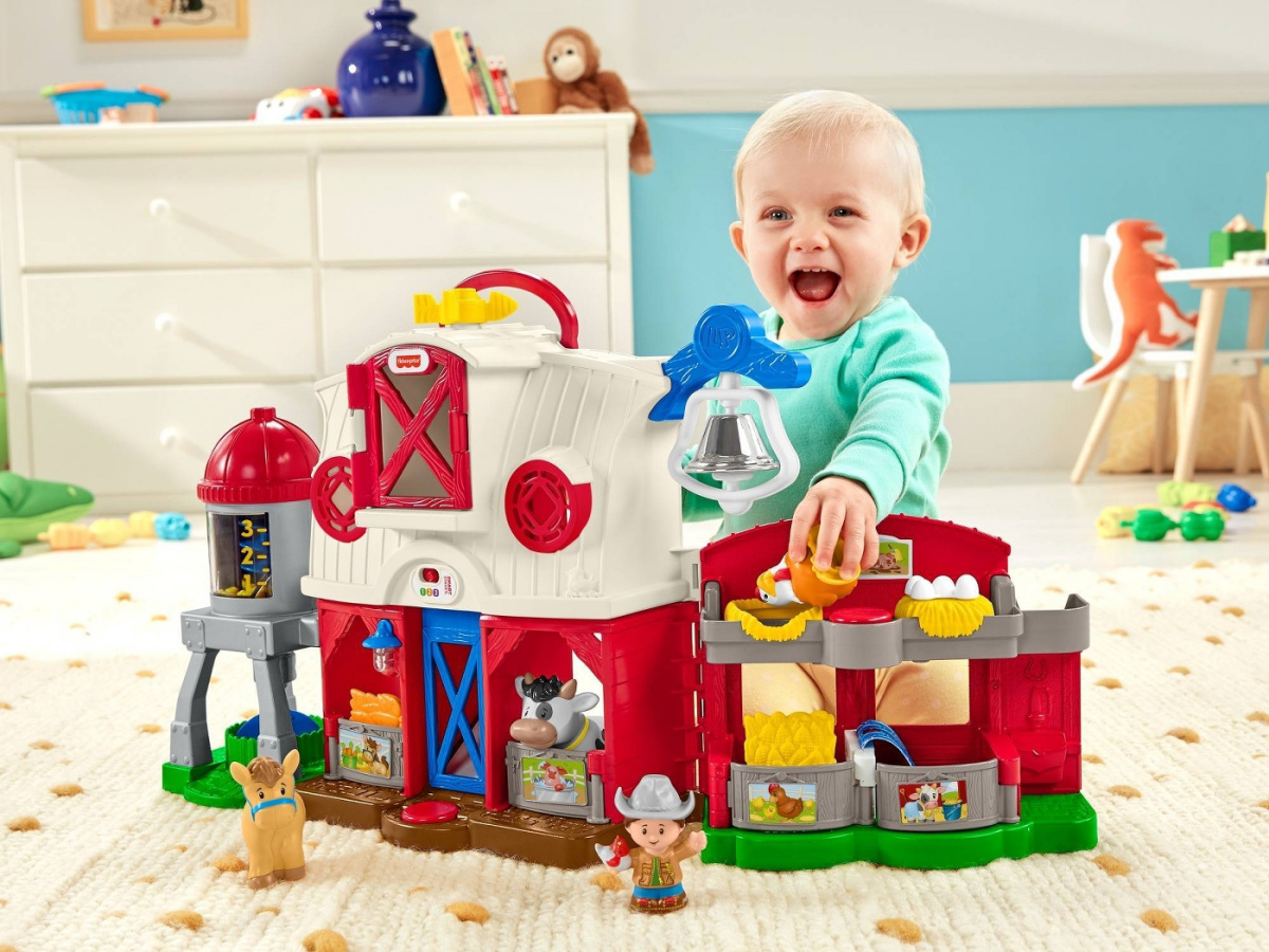 child playing with farm playset in playroom