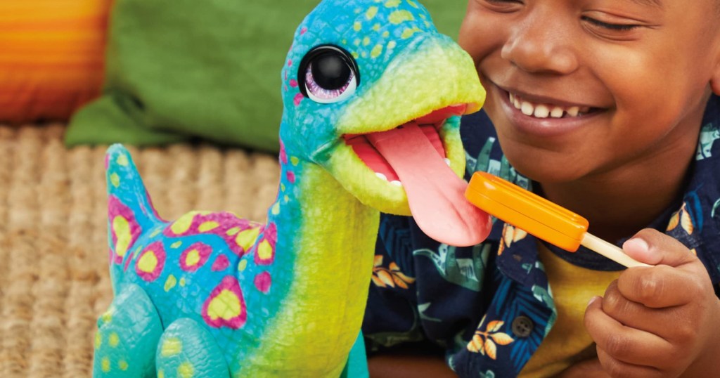 boy playing with interactive dinosaur toy