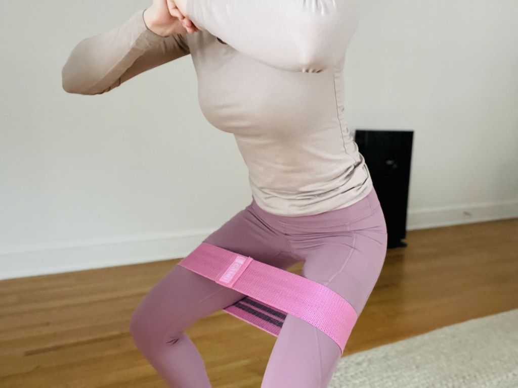 woman squatting with a resistance band
