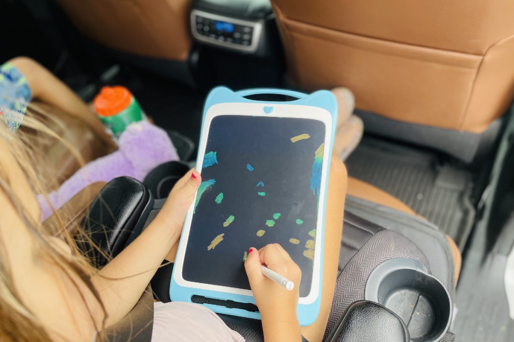 Girl using Jasonwell Kids Drawing Pad in Car