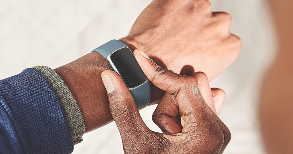Guy checking Fitbit Charge on wrist