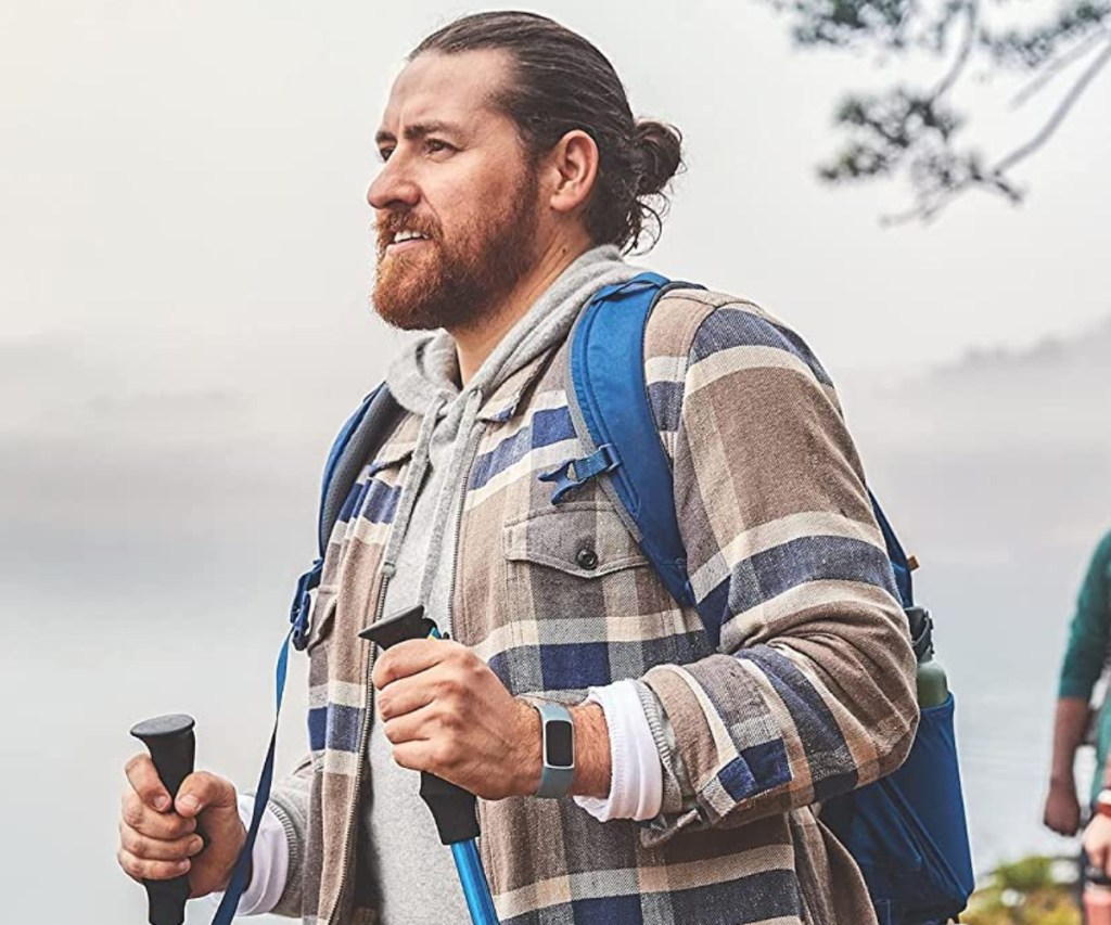 Guy hiking with Fitbit